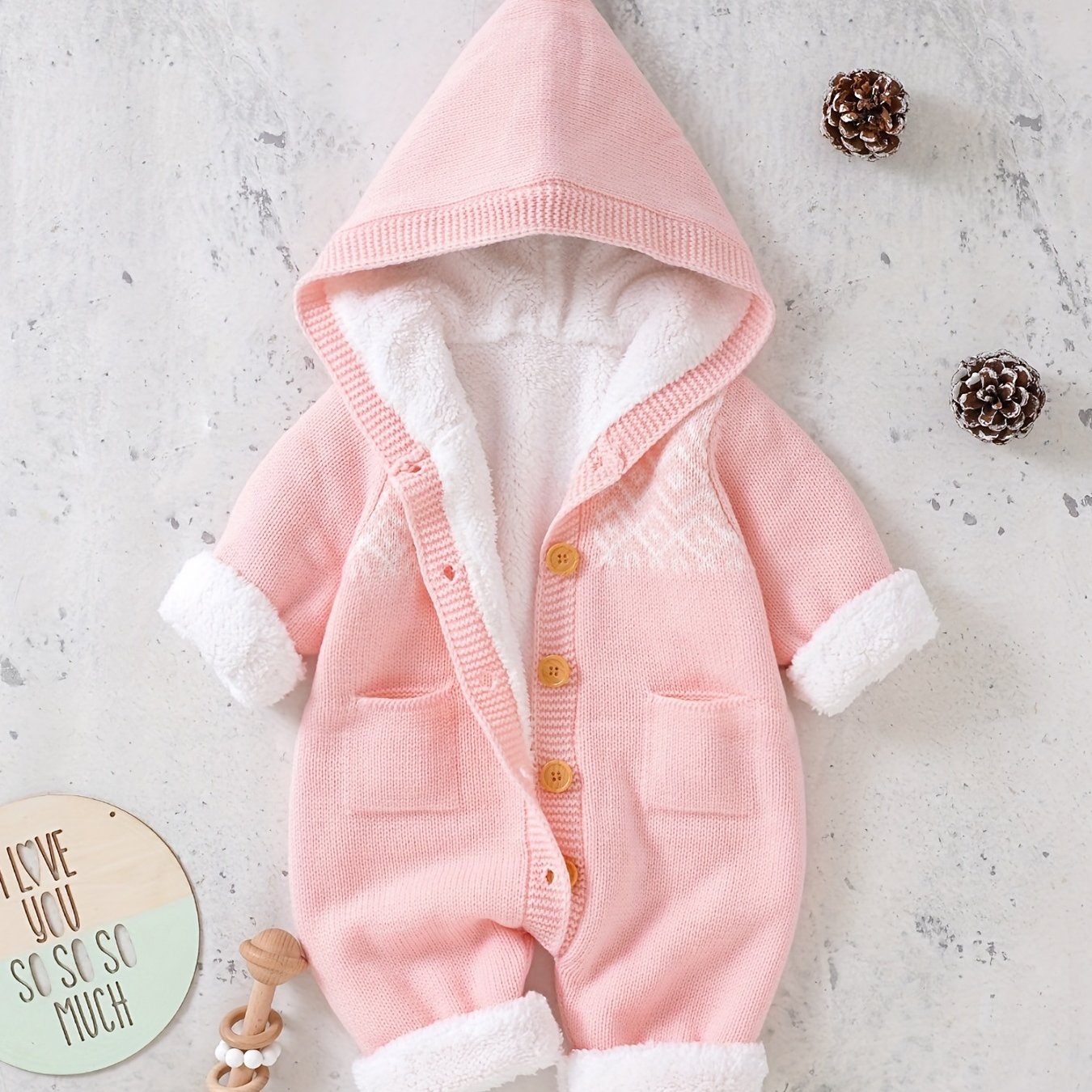 Knitted jumpsuit for newborn boys and girls with long sleeves and hooded pants.