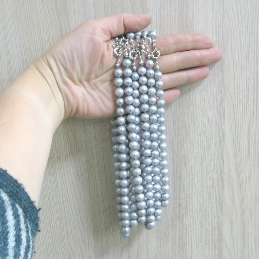 This MYSOYA natural freshwater pearl necklace is handmade with care and features 100% silvery gray pearls. The vintage elegant style and 10-12mm pearls make it a versatile piece of unisex jewelry. It comes in a beautiful gift box, making it the perfect