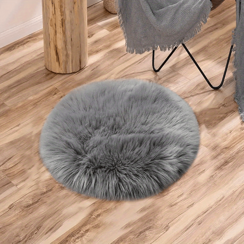 Round luxury area rug made from soft faux fur material with high pile and knit weave, machine washable, lightweight and fluffy. Crafted from a blend of polyester and acrylic in a solid color design. Perfect for adding a cozy touch to bedroom, living