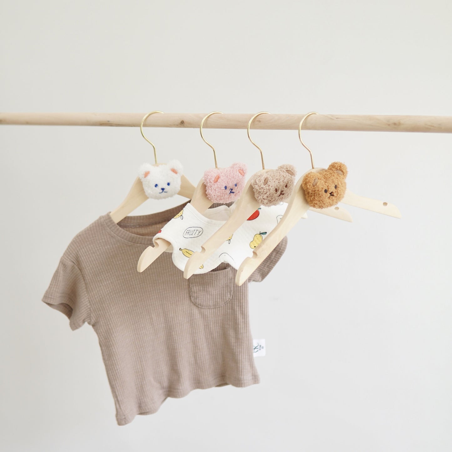 Durable and Lightweight Wooden Clothes Hangers featuring a Nordic Style Cartoon Bear Design, with Swivel Hooks for easy maneuvering. Recommended for Ages 14 and up.