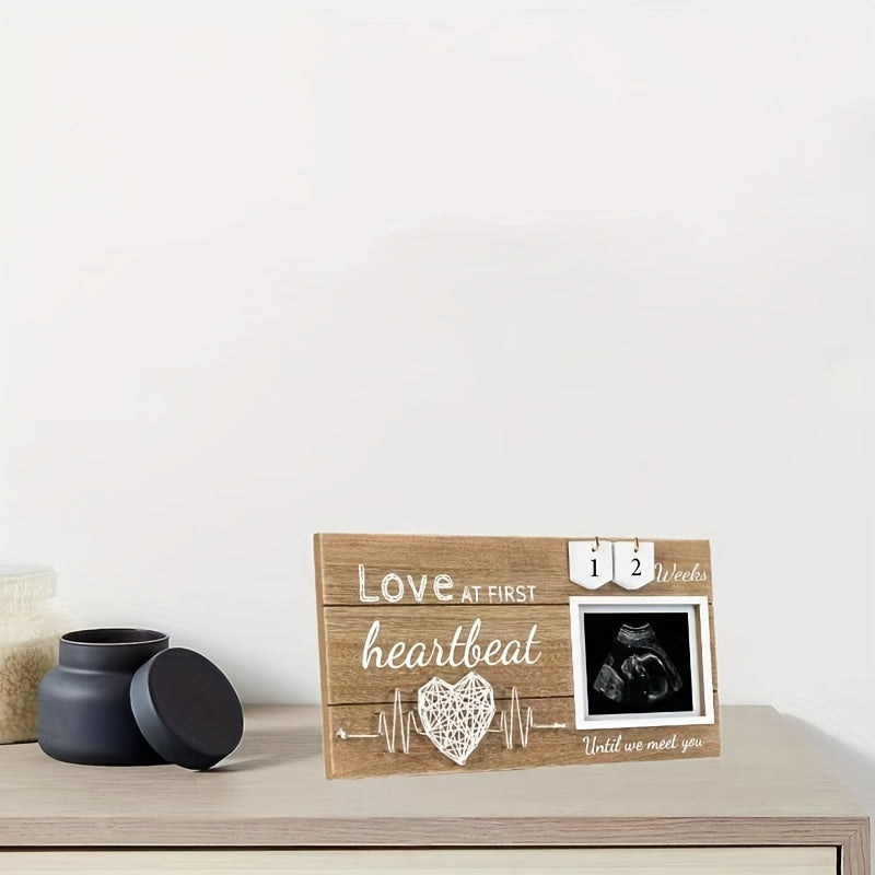 Baby countdown photo frame made of wood featuring a heartbeat design. This newborn keepsake frame is suitable for children aged 0-3 years and comes with interchangeable week tracker blocks.