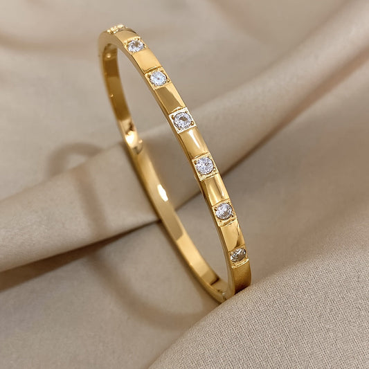 This exquisite rose gold stainless steel bracelet with sparkling rhinestones makes a stunning and opulent gift for your family, loved ones, and friends.