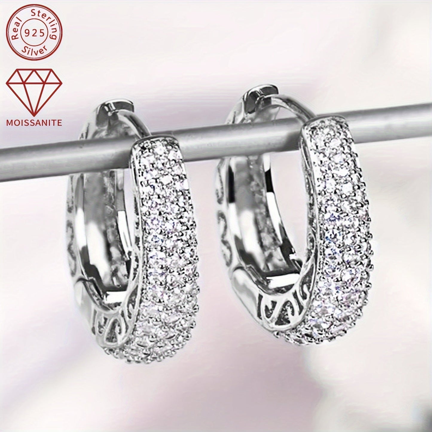 These exquisite women's fashion earrings are made entirely of Moissanite and weigh 8.03g. They feature a stunning pattern of 1.4mm, 1.2mm, 1mm, and 0.8mm Moissanite stones, as well as two 0.43ct Moissanite stones. Crafted in 925 silver, this pair of