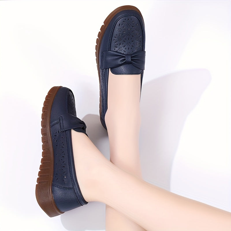 Flat loafers for women with hollow out design, bow detail, soft sole, suitable for casual walking.