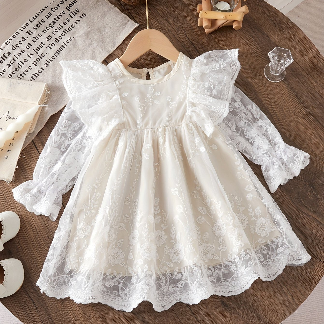 Infant girls' mesh dress with floral embroidery and chic style.