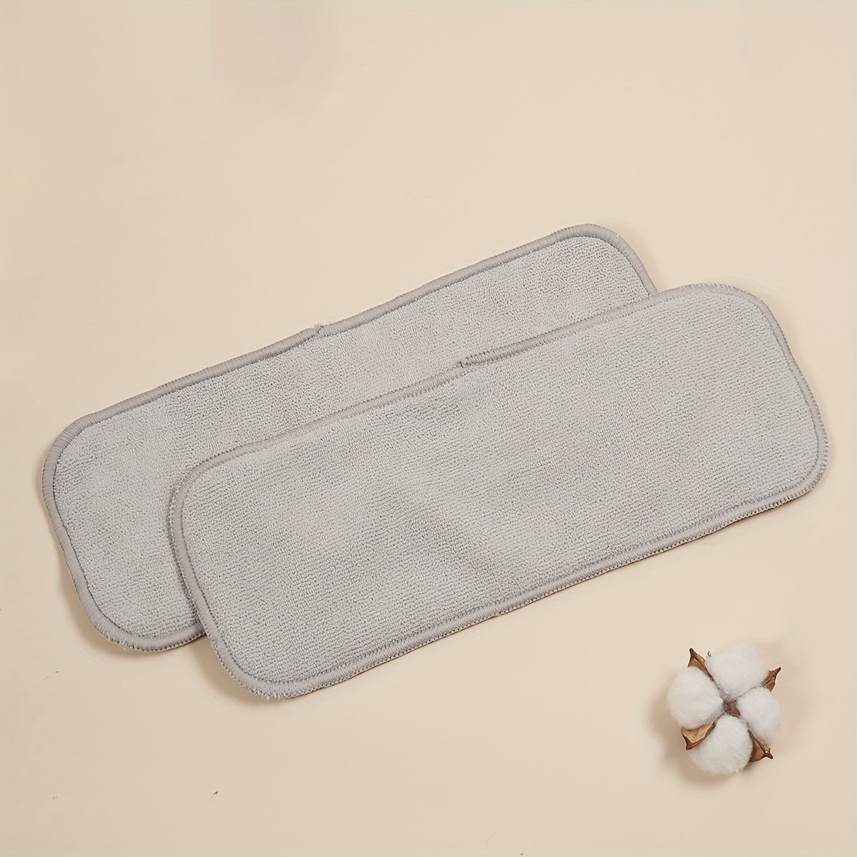 Two pieces of absorbent microfiber cloth pads, including 3-layer washable microfiber diaper inserts.