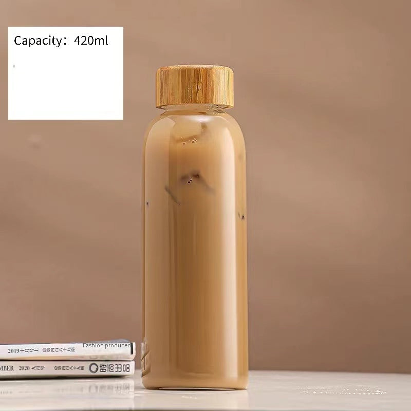 This borosilicate glass bottle comes with both a stainless steel lid and a wooden bamboo lid, making it perfect for travel and storing a variety of beverages such as juice, smoothies, kombucha, kefir, and tea. It is 100% leakproof and can be safely used