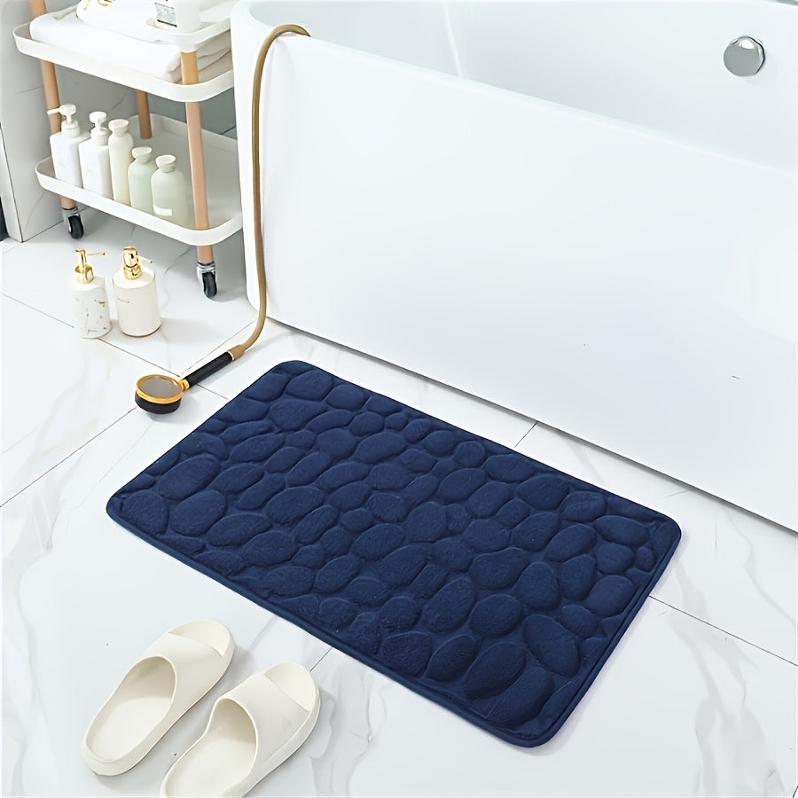 One piece of bath mat with embossed pebble pattern, highly absorbent and non-slip for bathroom use. Suitable for tub, toilet, and floor, made of machine washable polyester material. Dimensions are 59.94x39.88 cm.