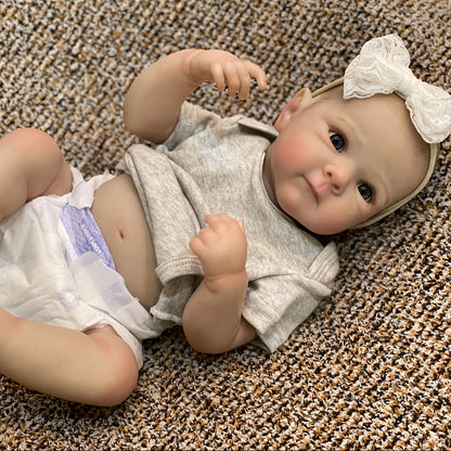 20" lifelike waterproof vinyl reborn girl doll with realistic 3D painted skin and hand-painted hair. Bathable and comes in a comfy gray outfit with headband. Perfect for girls.