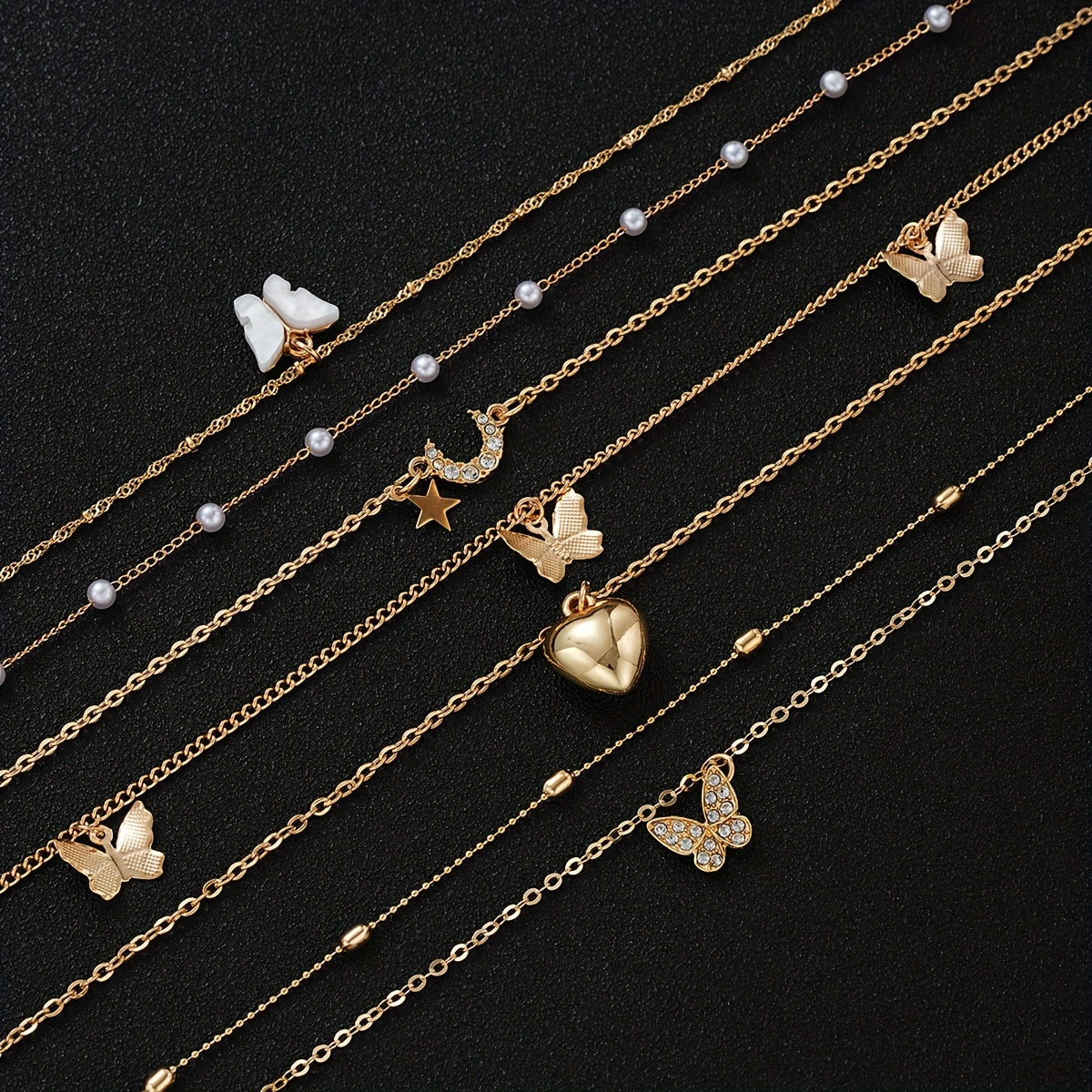 Set of 11 pieces featuring faux pearl and rhinestone star, butterfly, and heart necklaces for women. This fashion stacking jewelry set is perfect for daily wear, dates, holidays, and parties. Ideal for adding a simple and vacation style to any outfit.