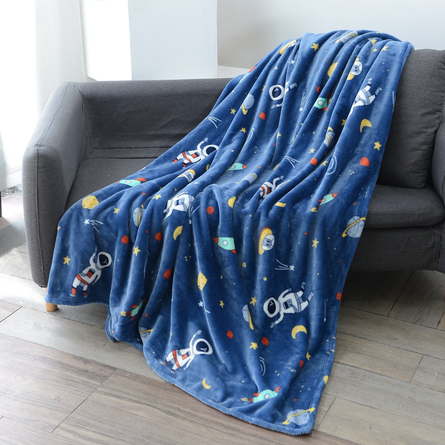 Warm and soft Cozy Astronaut Flannel Throw Blanket with Space Theme - Reversible for couch, bed, office, and travel. Perfect for galaxy lovers, nap time, and adding a touch of mission and wavering style to any space.