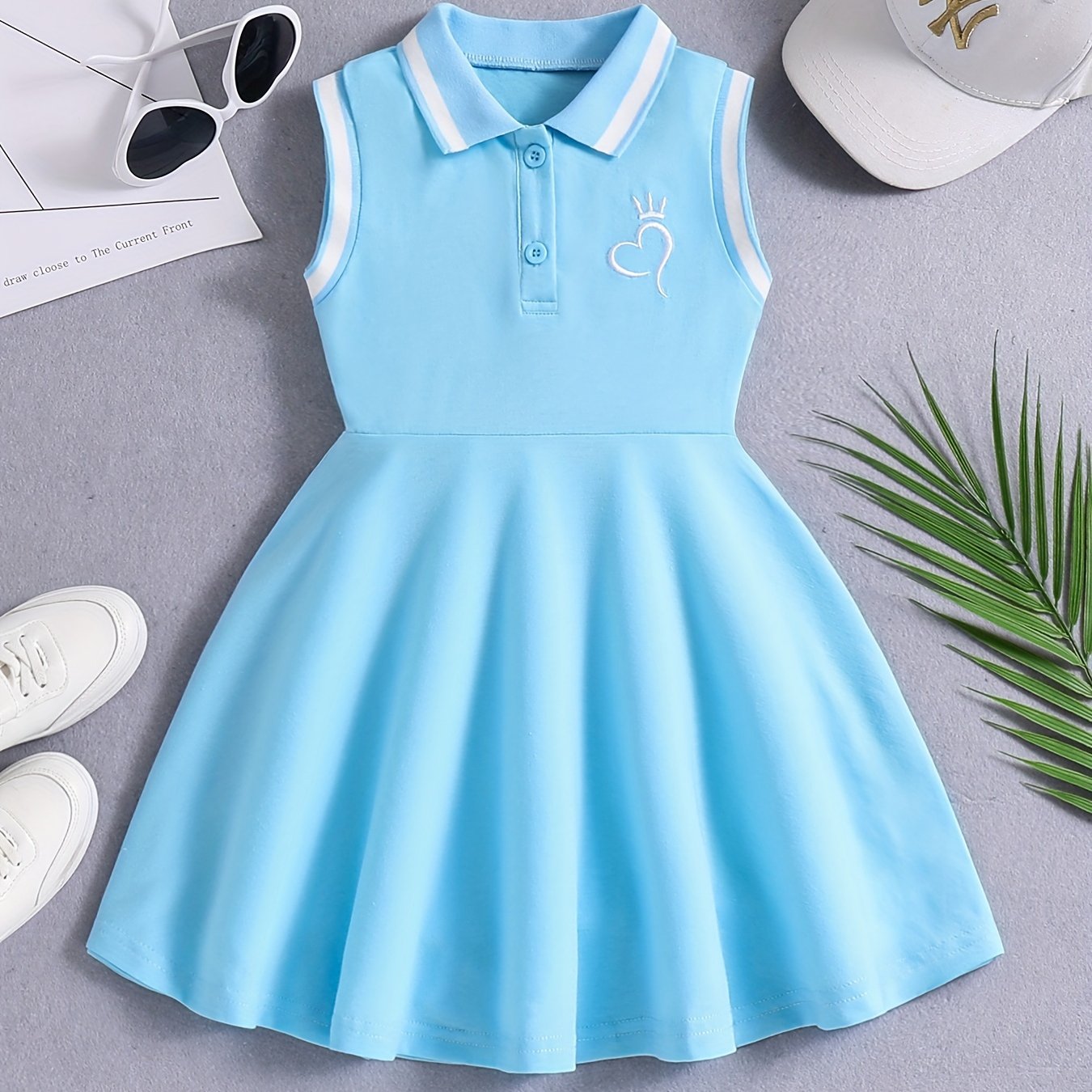 Girls' Red Tennis & Athletic Dress in sporty elegance featuring breathable, sweat-absorbent polyester with stretch and sleeveless design with black lettering for sports and casual wear.