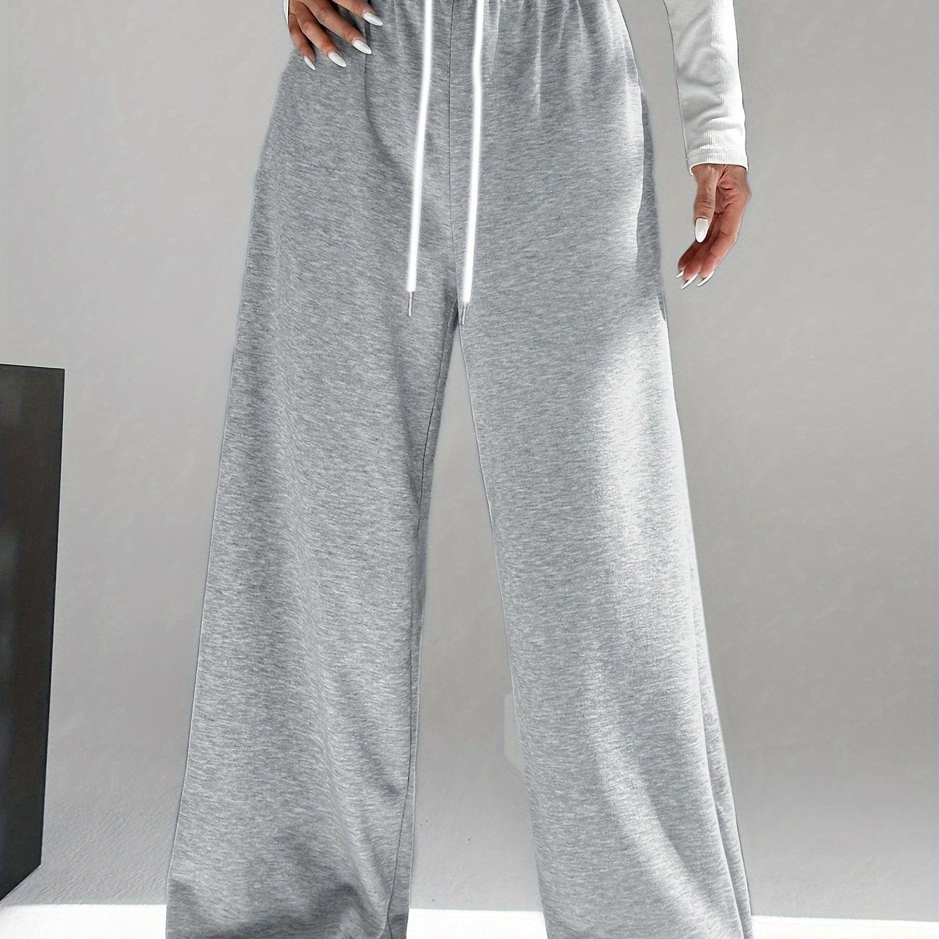 High waist wide leg drawstring pants in contrasting colors for women's spring and fall attire.