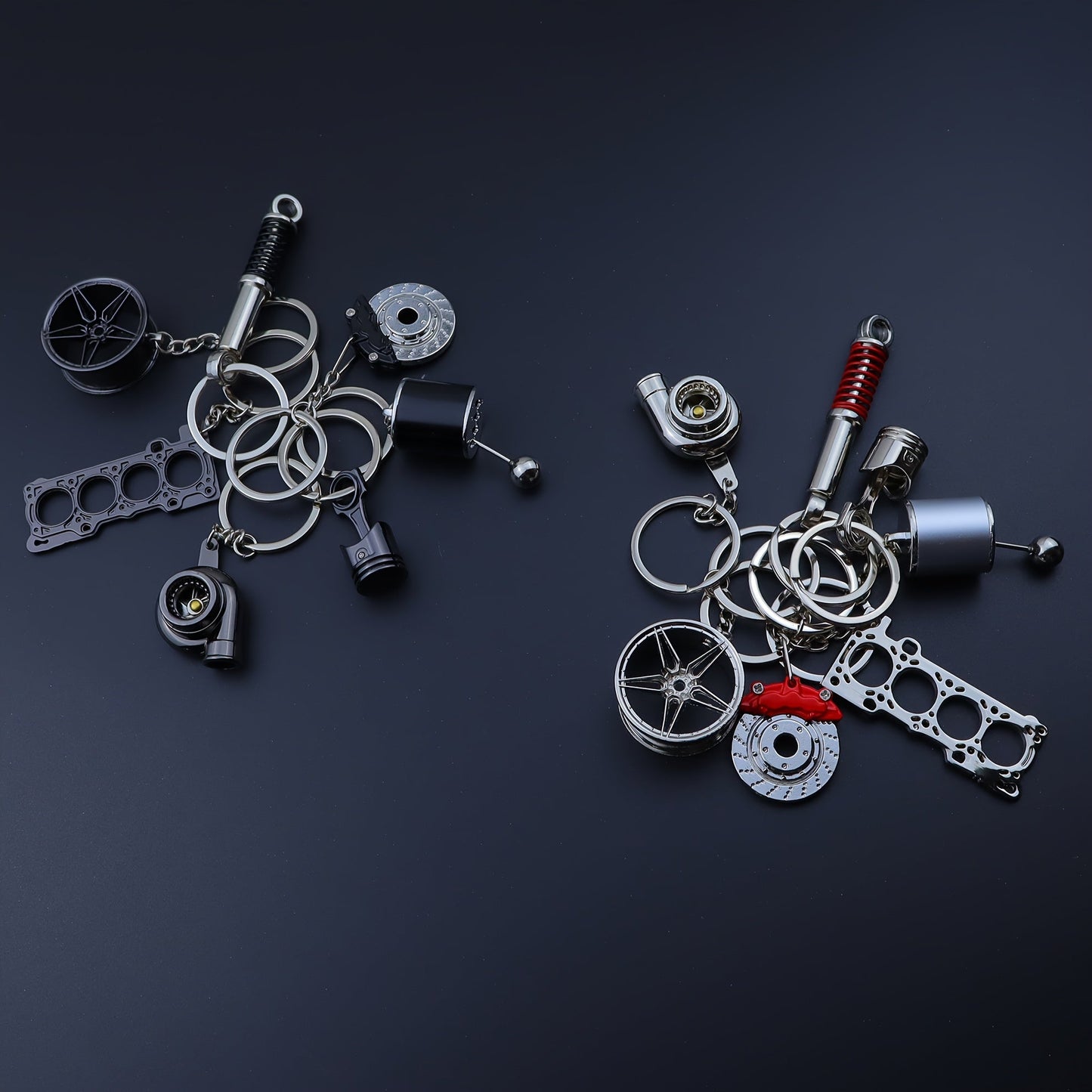 Funky car modification keychains set includes seven pieces: piston, turbo, wheel hub, gear shift, shock absorber, brake disc, and engine block. Made of zinc alloy in a sleek black finish.