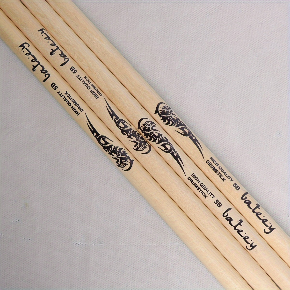 Lightweight drumsticks with totem design, selectable sizes 5A, 7A, and 5B. Made of high-quality natural wood with a precision grip, uncharged pair.