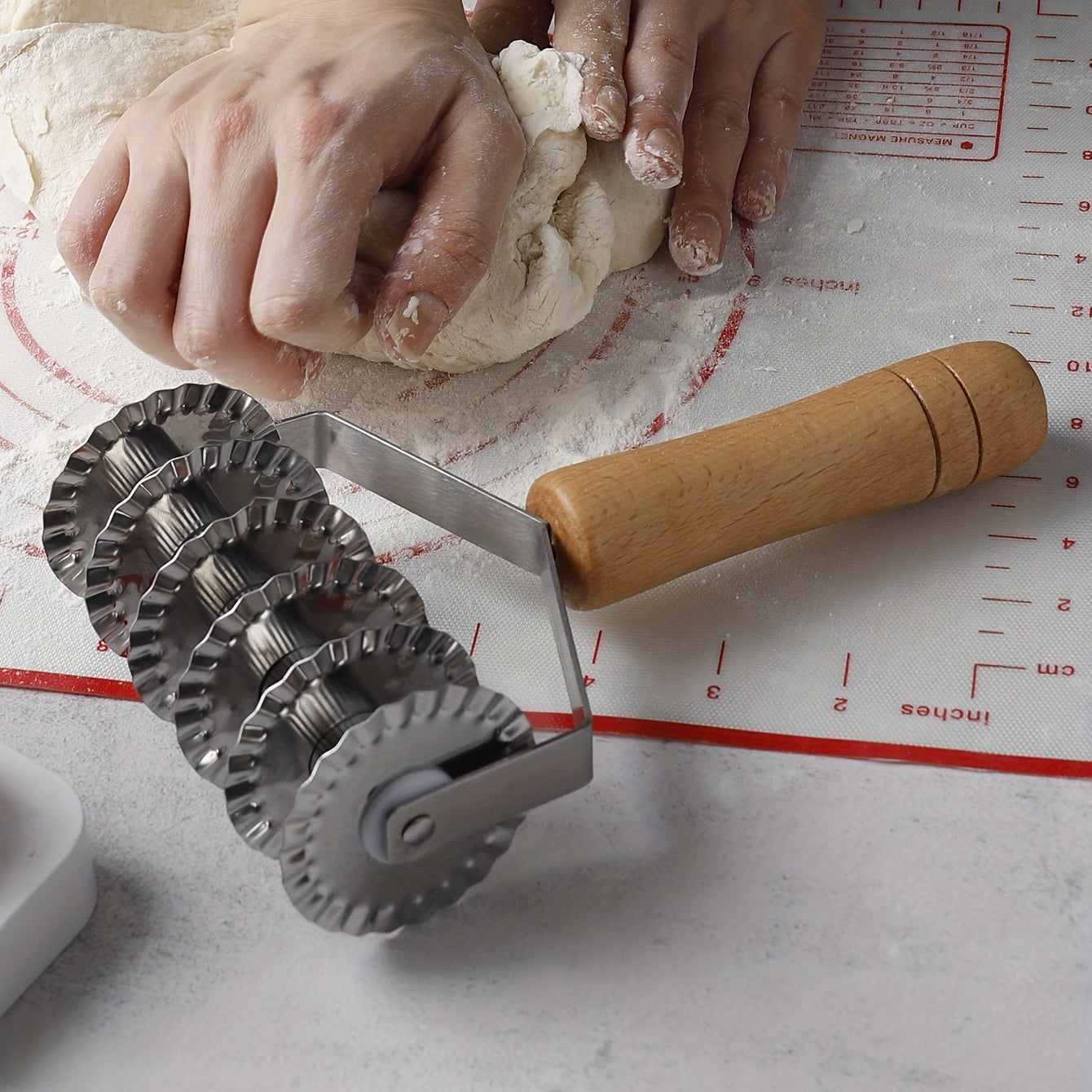 Six-wheel stainless steel cookie and noodle cutter with a wavy wood handle - Perfect for cutting cookies and noodles in the kitchen.