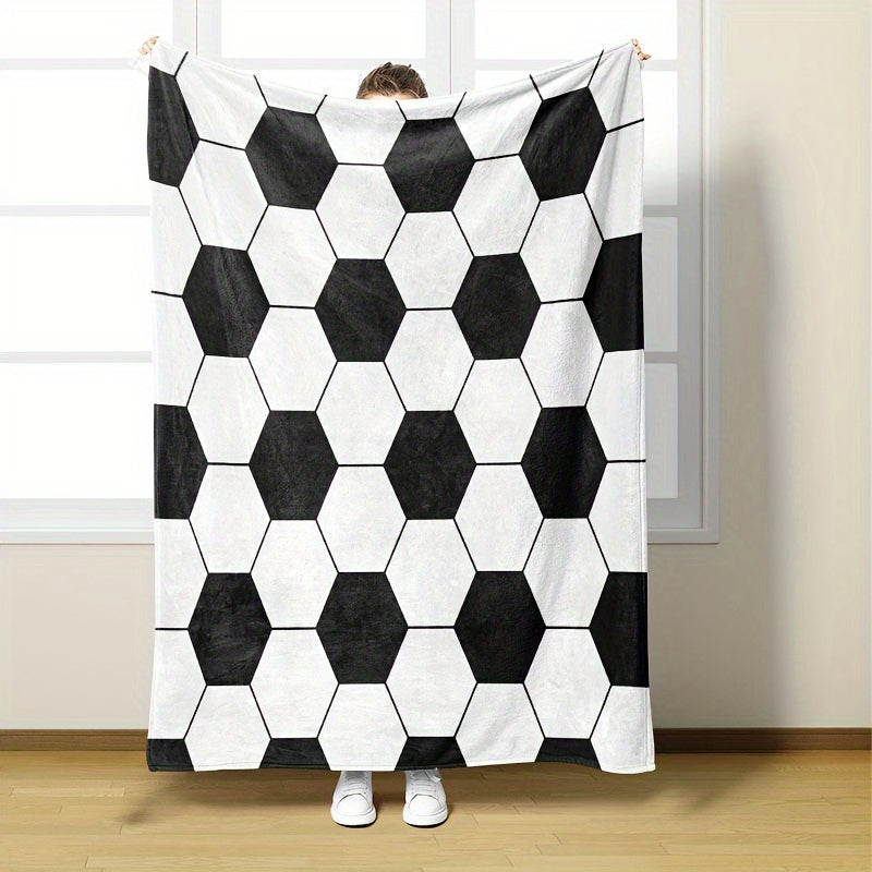 Soft and cozy football-themed blanket for kids made of flannel, featuring a hexagonal black and white soccer ball pattern. Perfect for bed, sofa, travel, and camping. Ultra-soft, lightweight, and warm. Machine washable. Ideal for both bed and sofa.