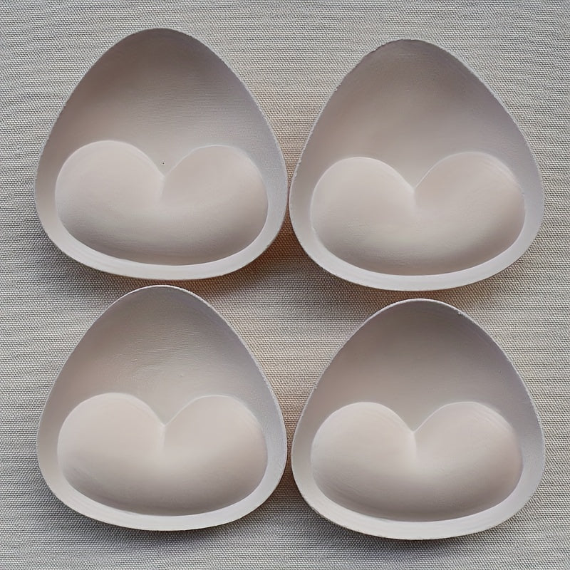 2 pairs of heart-shaped sponge bra inserts, washable and removable cup enhancers for bikinis, tops, and bras. Made from soft and breathable PU material for comfortable fit.