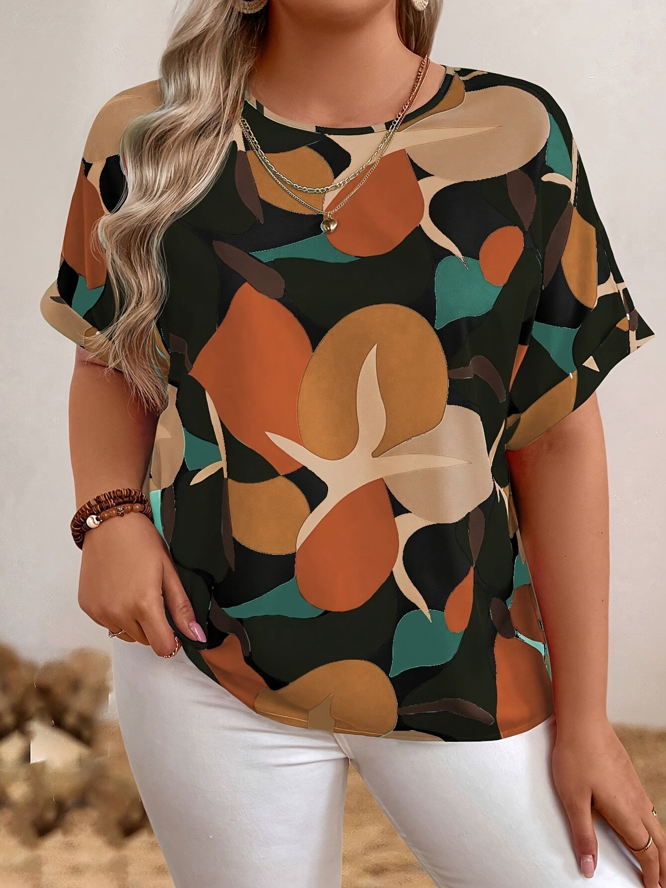 Plus size floral print batwing sleeve blouse in orange, brown & green camouflage design for women. Casual crew neck summer top.