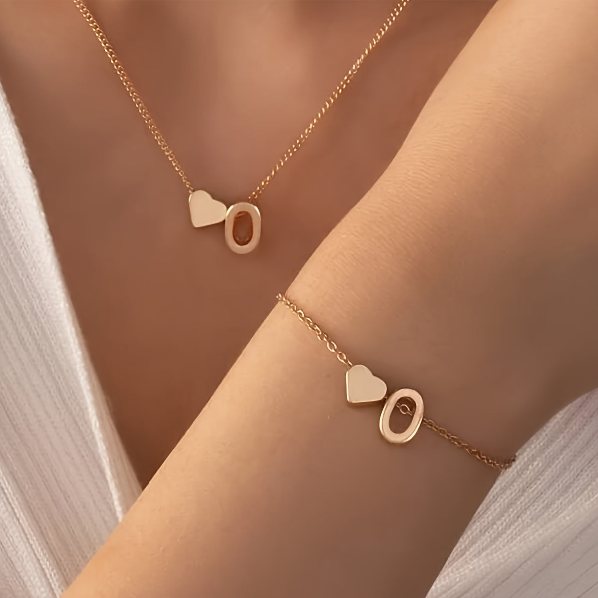 Chic two-piece set with metal heart and letter necklace and bracelet, ideal for daily wear.