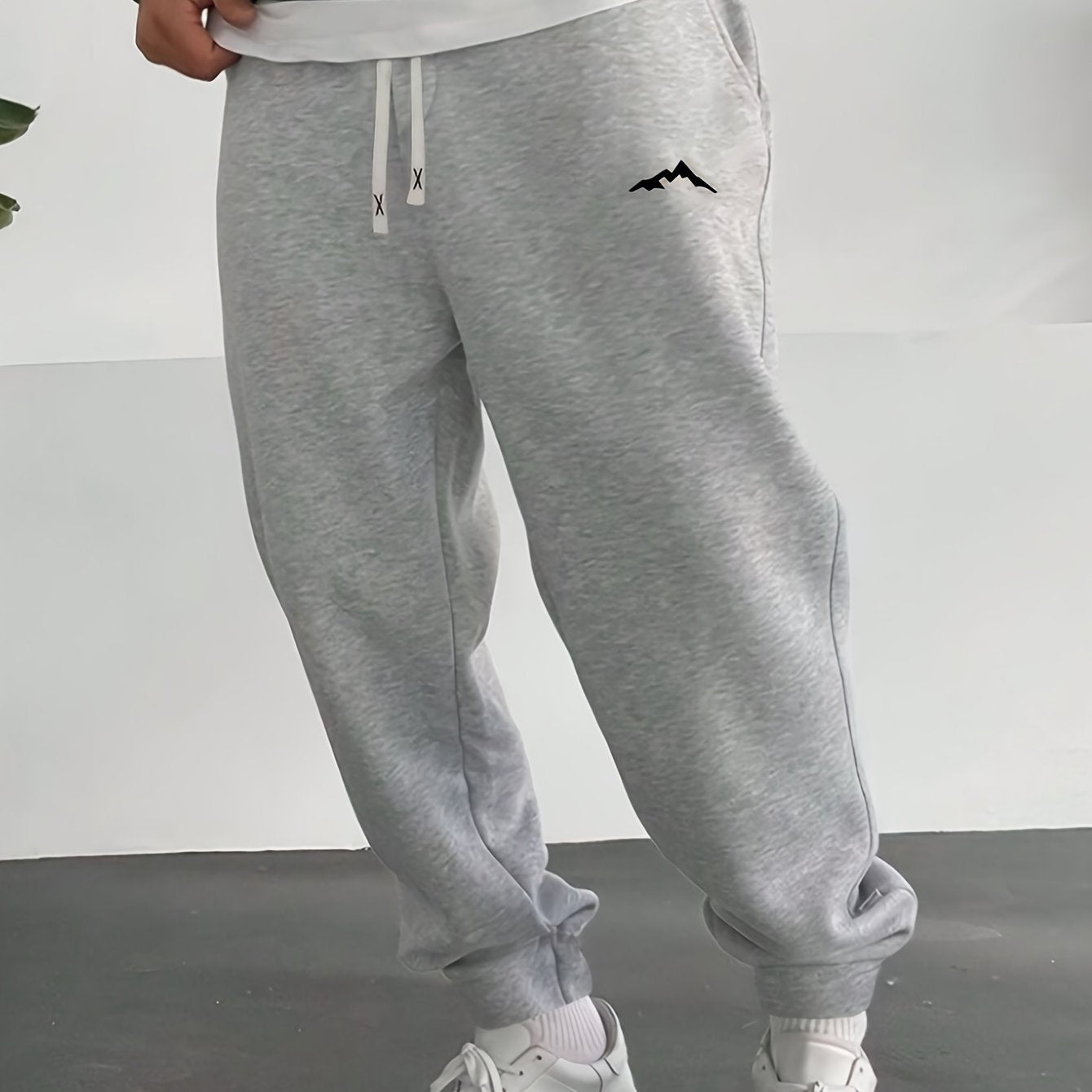 Plus size men's fleece-lined sweatpants with stylish mountain print, drawstring waist, and machine washable polyester for fall/winter. Casual and stylish joggers.