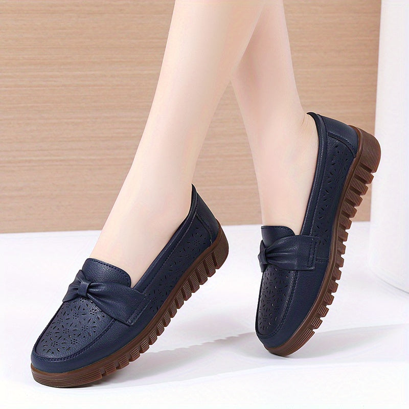 Flat loafers for women with hollow out design, bow detail, soft sole, suitable for casual walking.