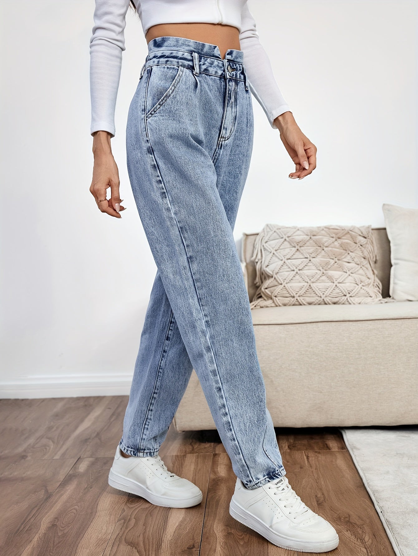 Women's light blue high-waisted straight-leg denim jeans with slash pockets, button closure, and non-stretch cotton material for casual spring/fall wear.