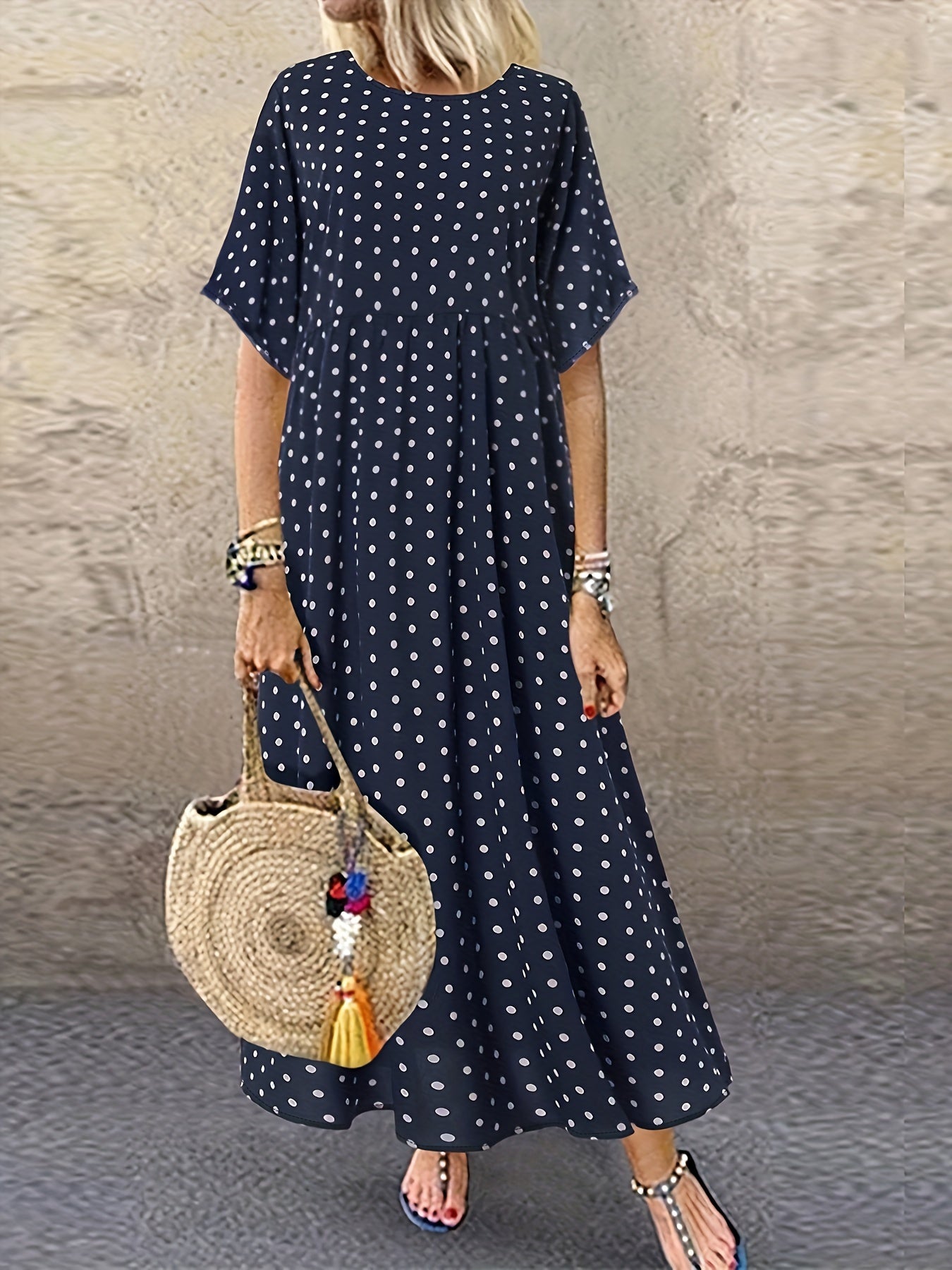 Machine washable navy blue midi dress with white polka dots, short sleeves, round neck, and ruffle detail.