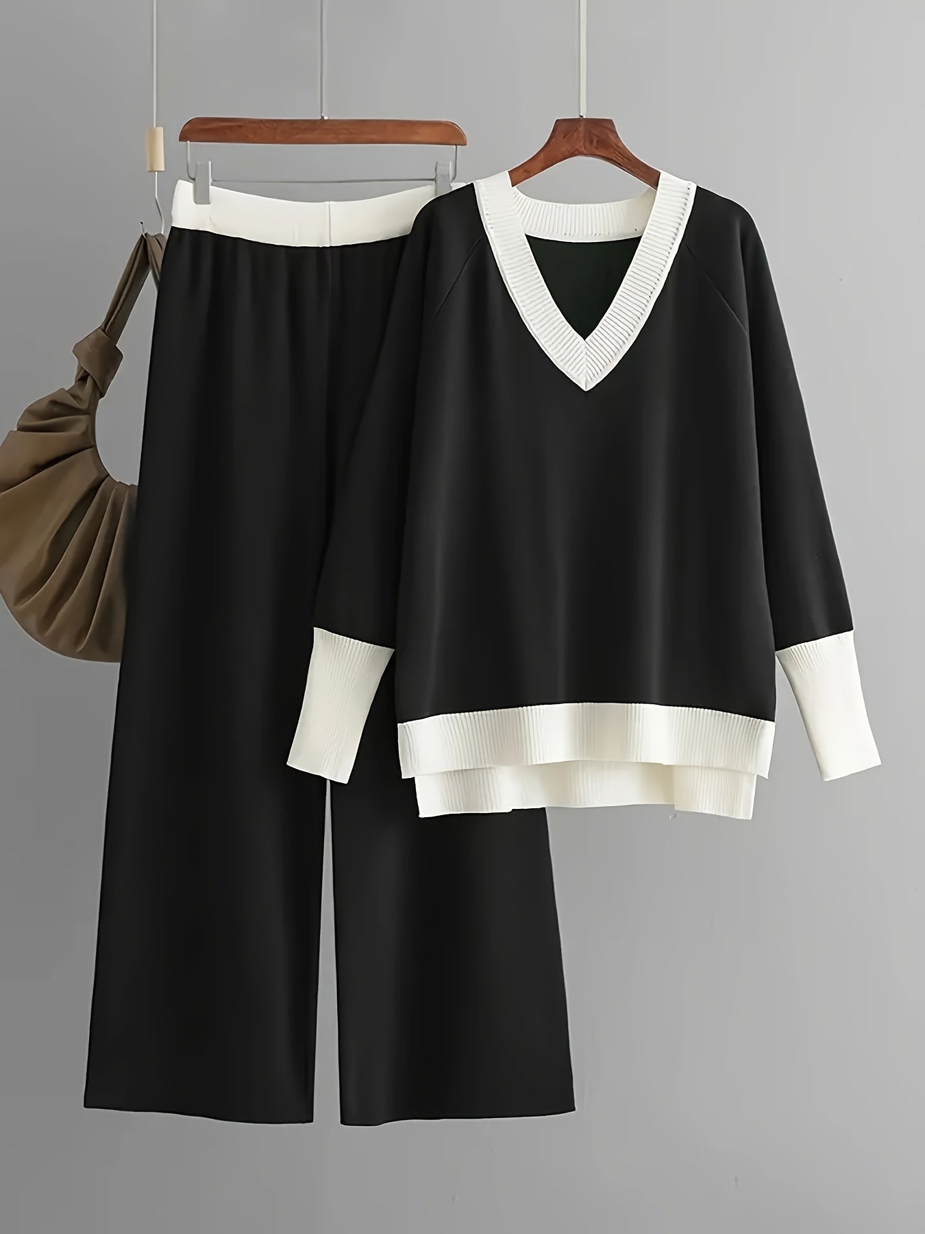 Viscose knit two-piece outfit for women, including a color block V-neck sweater and matching trousers in a solid color.