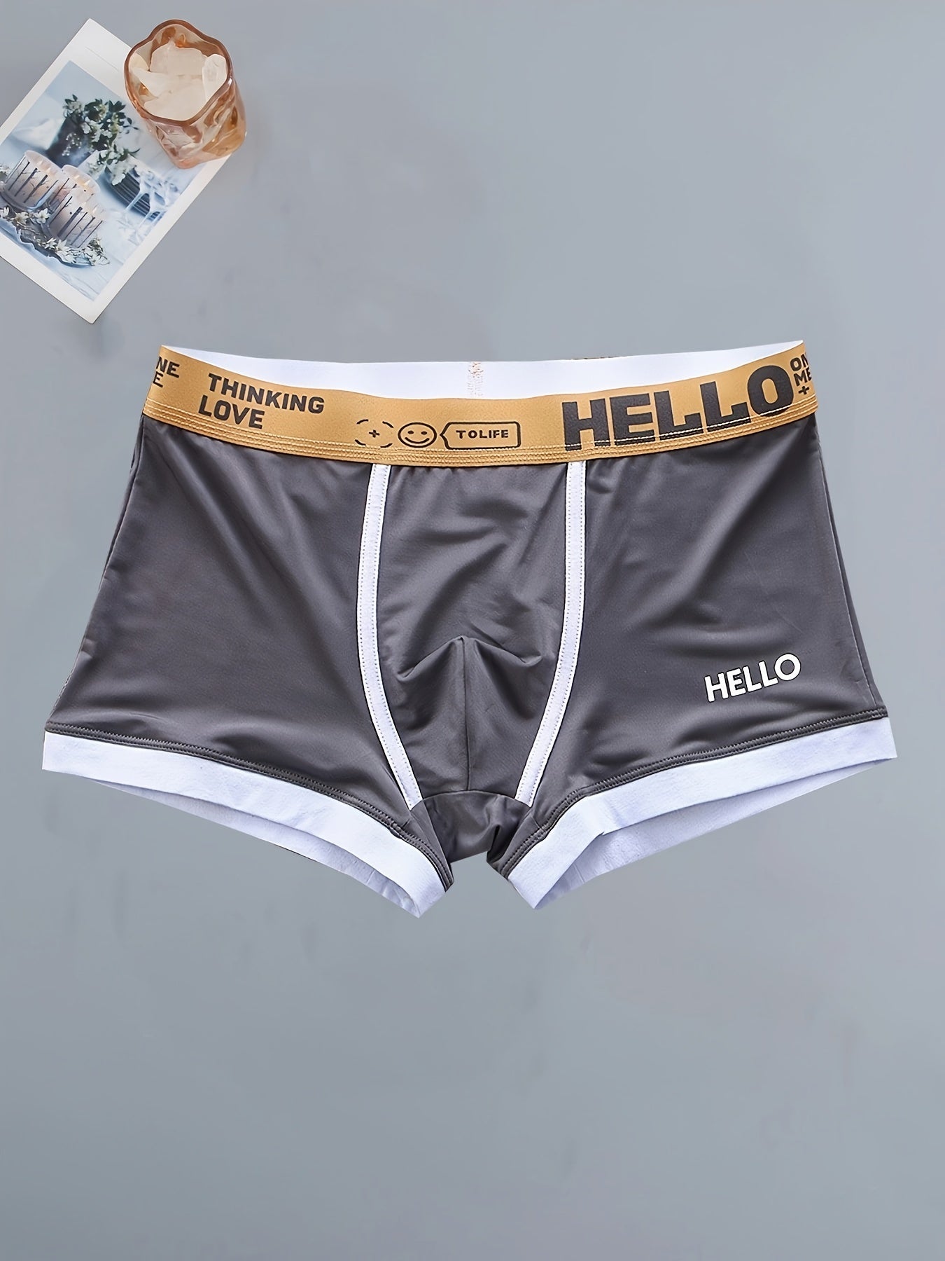 4 men's boxer briefs made with soft, breathable polyamide and elastane fabric featuring an alphabet pattern.