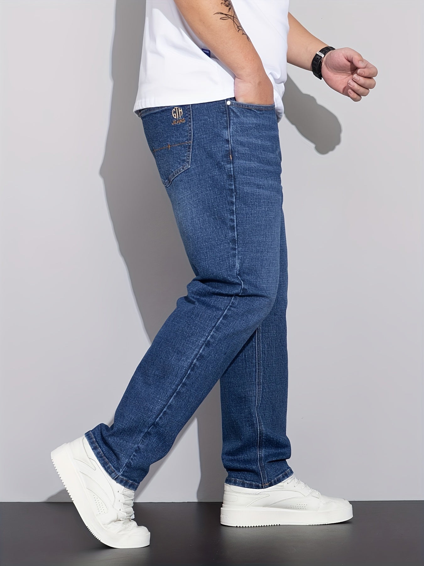 Men's plus size denim jeans with comfort flex, straight leg, washed detail, solid color, cotton blend with stretch.