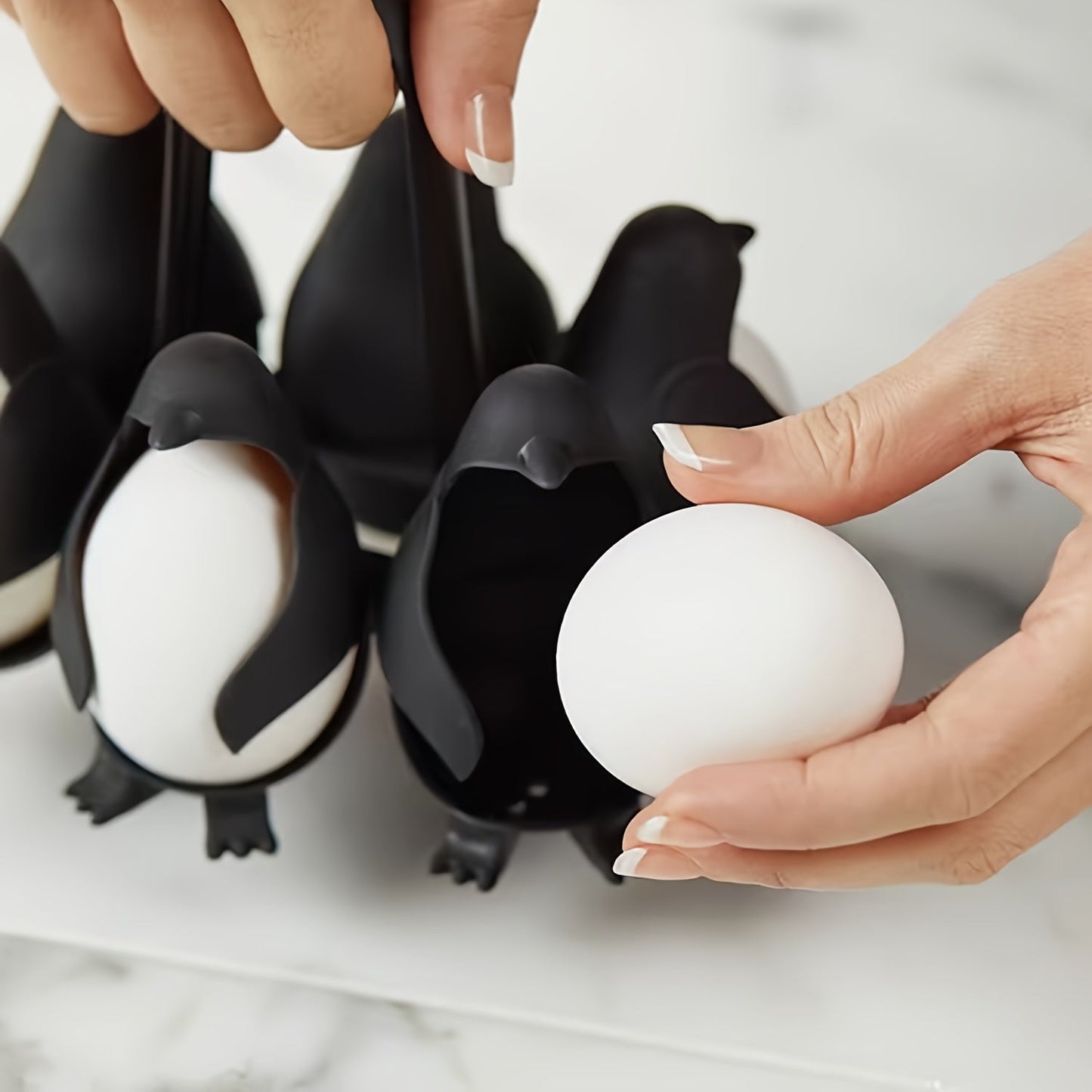 A set of 6 Penguin Egg Cookers made of plastic, perfect for boiling both hard and soft eggs. This food-safe kitchen gadget is a great gift idea for Christmas, Thanksgiving, Mother's Day, and Labor Day.