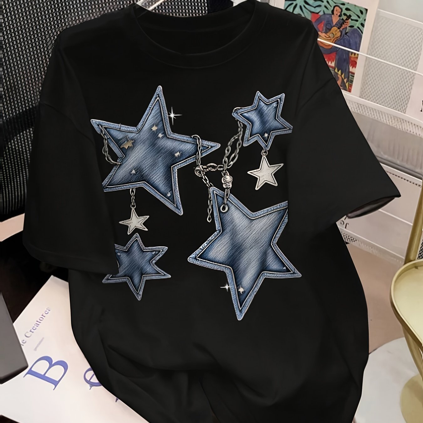 Women's graphic tee with sun, moon, and stars design, short sleeves, crew neck, stretchy polyester blend, machine washable.