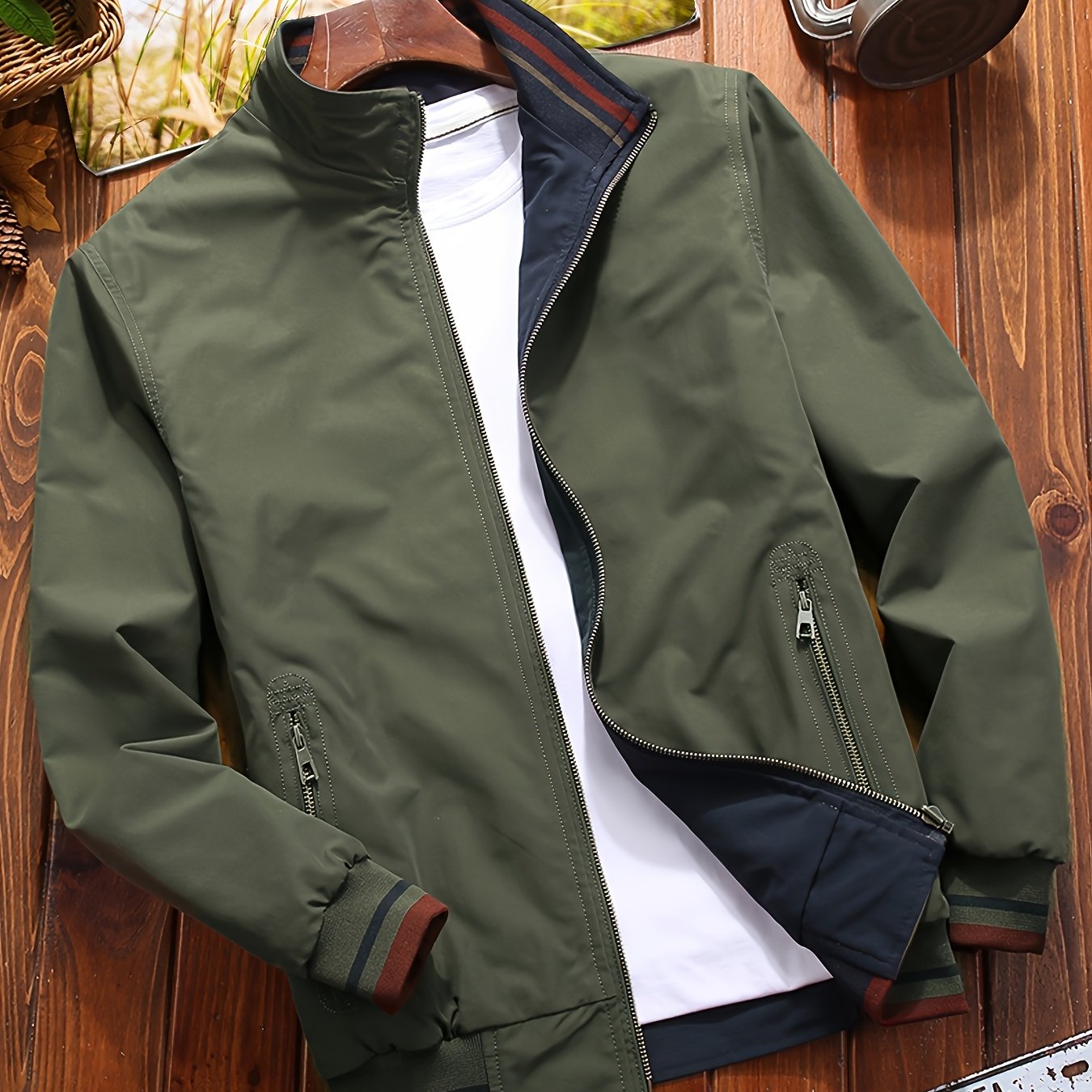 Reversible windproof jacket for men with military-inspired design, zip-up front, pockets, and long sleeves.