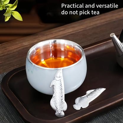 1 piece of silvery tea ceremony accessories for making tea and boiling water, a silvery dragon fish tea pet, and a silvery leaf for sterilizing and softening water quality.