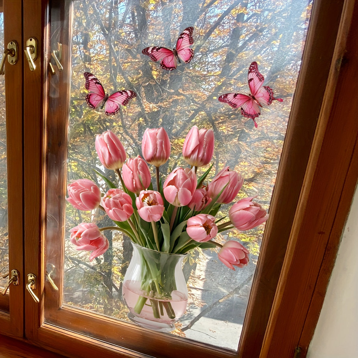 Contemporary Style Pink Tulip Butterfly Window Stickers, featuring a Floral Patterned design. Made from Polyvinyl Chloride Material, these stickers are easy to apply with their Static Cling Mounting and are reusable. Available in Assorted Shapes, these