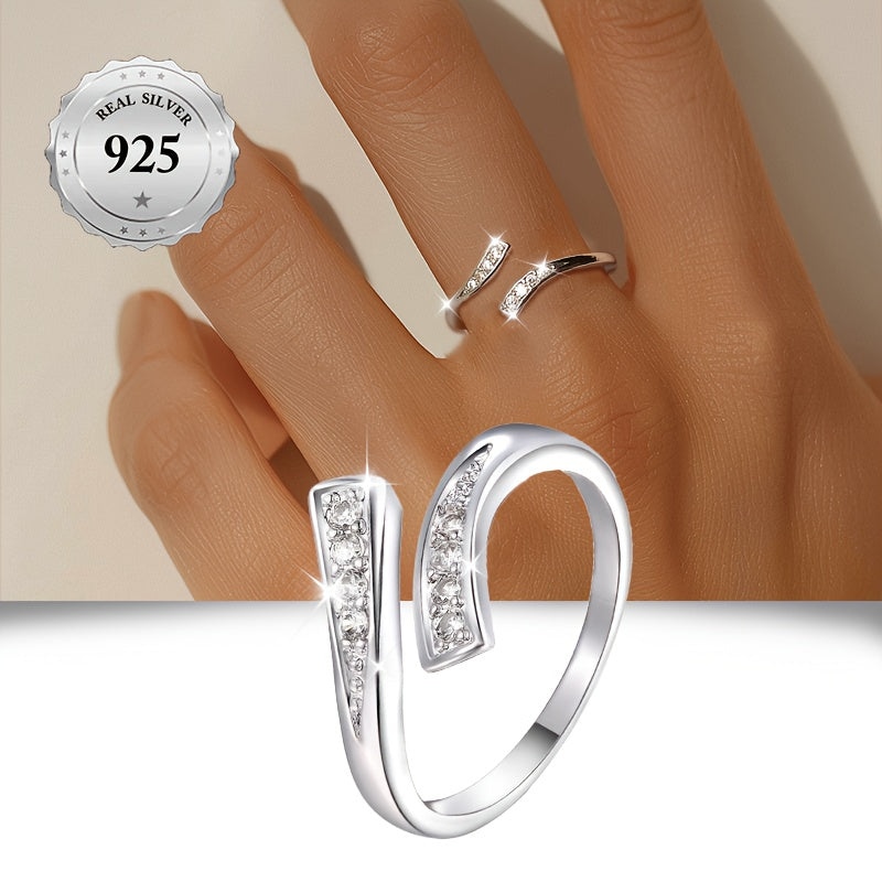 A stylish women's open ring featuring an infinity symbol and an endless loop design adorned with sparkling synthetic cubic zirconia for added bling. This minimalist and classic piece is made from lightweight 1.5g 925 sterling silver, making it suitable