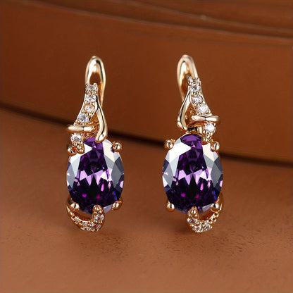 Trendy women's earrings featuring blue, white, red, and pink stones in round and oval cuts. These anniversary claw earrings are plated with 18K gold. Perfect for adding a pop of color to any outfit.