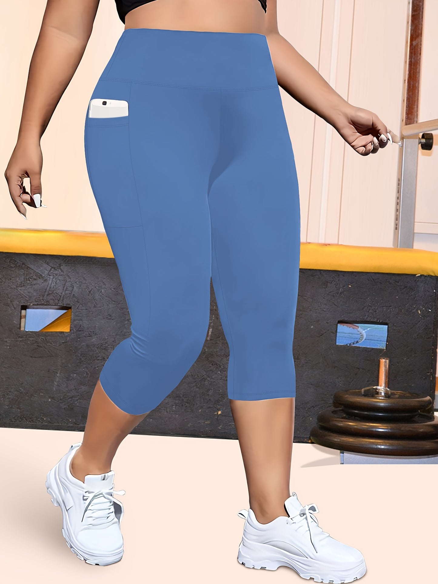 High-waisted capri leggings for plus-size women with side phone pockets, ideal for workouts.