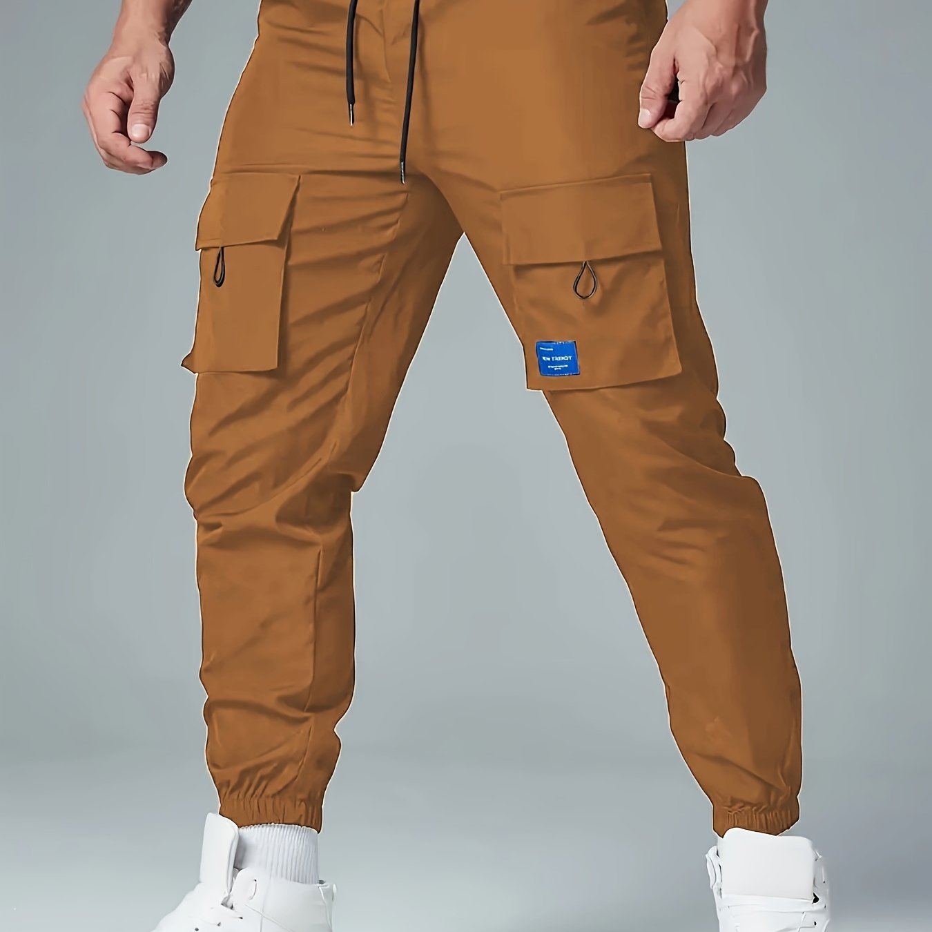 Men's casual drawstring cargo pants with multiple pockets made of polyester, mid-waist, ideal for spring and fall seasons.