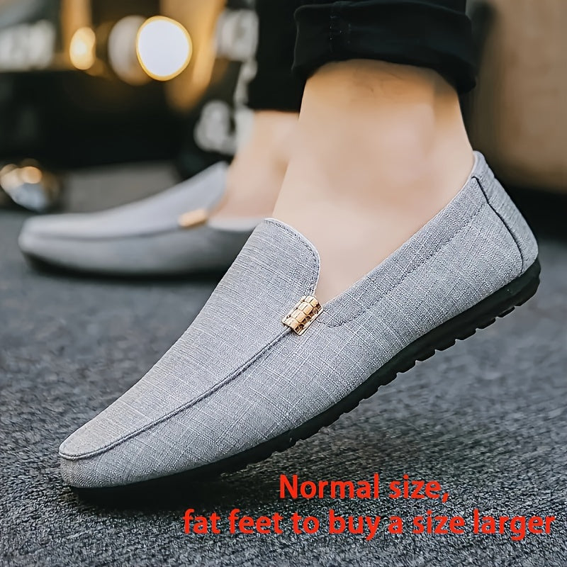 Men's black canvas loafers with metal decor, round toe, comfortable insole, suitable for casual and outdoor wear.