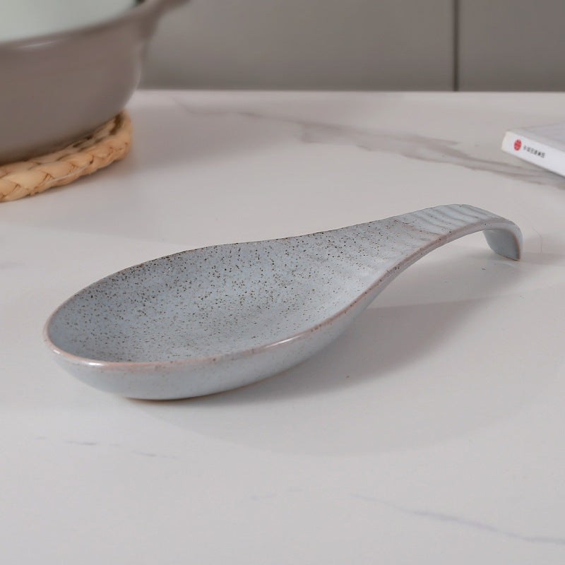 A single piece Ceramic Spoon Rest, beautifully handcrafted Soup Ladle Holder, featuring a Modern Country Style design. Perfect for organizing kitchen utensils, this European Vintage Creative Reaction Glaze piece comes with a practical Ladle Stand for