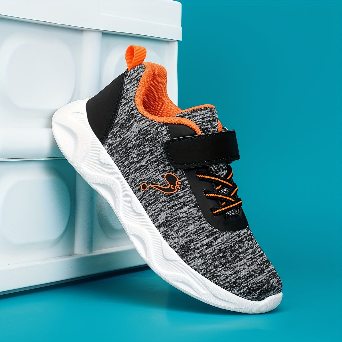 Breathable sneakers for kids with non-slip soles and hook and loop closure.