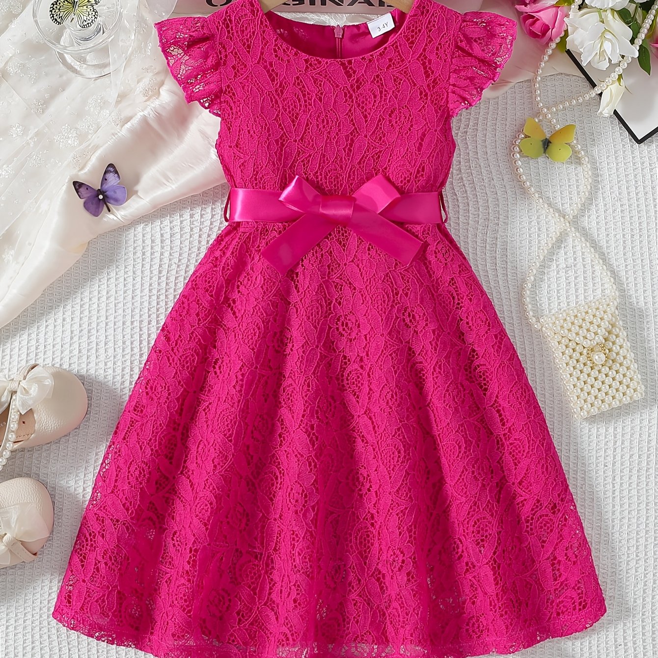 Girls' spring/summer dress with lace detail, belt, and flutter sleeves, ideal for daily wear or birthday parties.