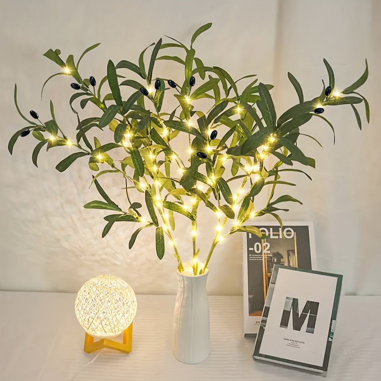 Olive Branch LED Lamp with Fairy Lights and artificial greenery tree. Ideal for various occasions. Mixed color, battery-operated with button control. Modern and festive accent.