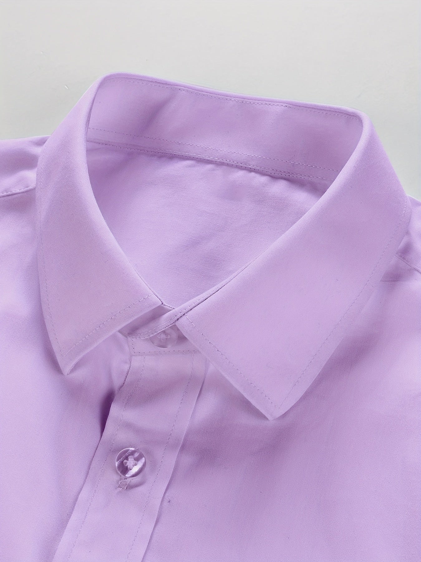 Classic men's button-down dress shirt in solid color, suitable for business casual office wear in the spring season.