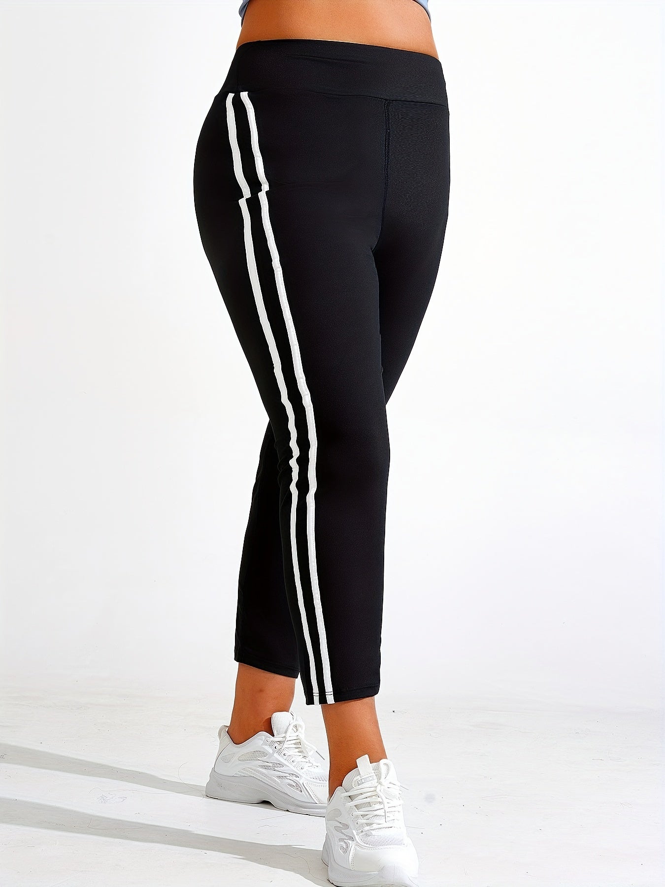 Plus size yoga pants for women, solid color, slimming fit, machine washable, long length, made of stretch polyester and elastane.