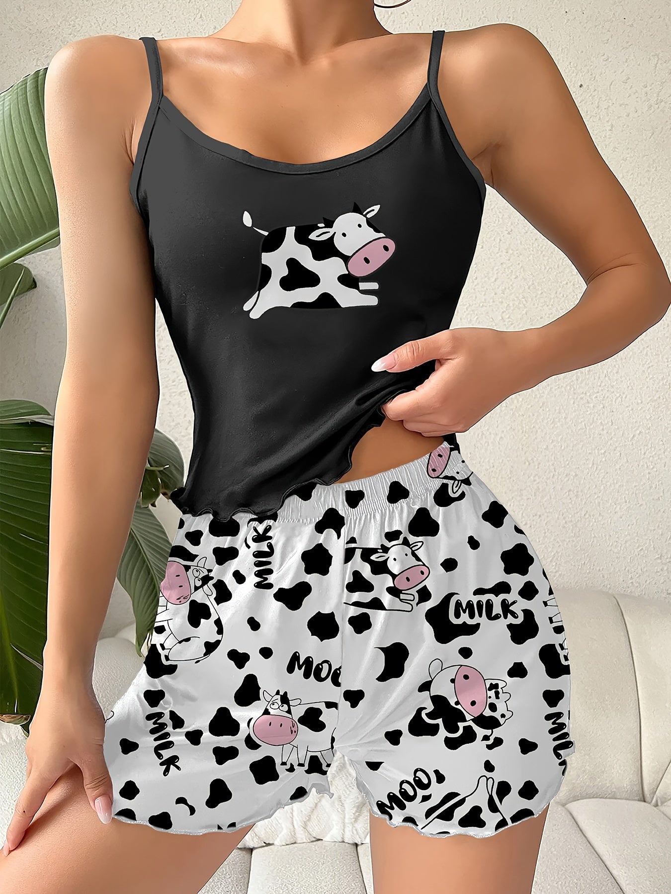 Cow print lounge set including a backless cami top and elastic shorts for women.