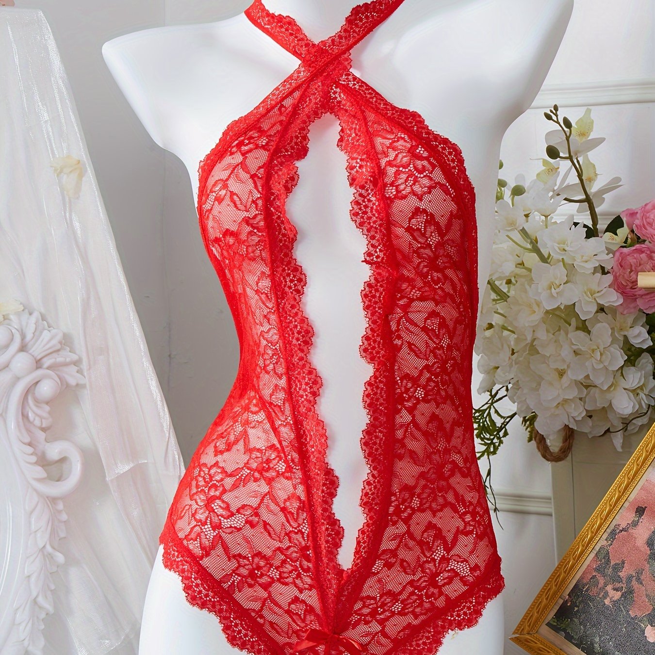 Red lace bodysuit with bow detail and floral print lingerie.