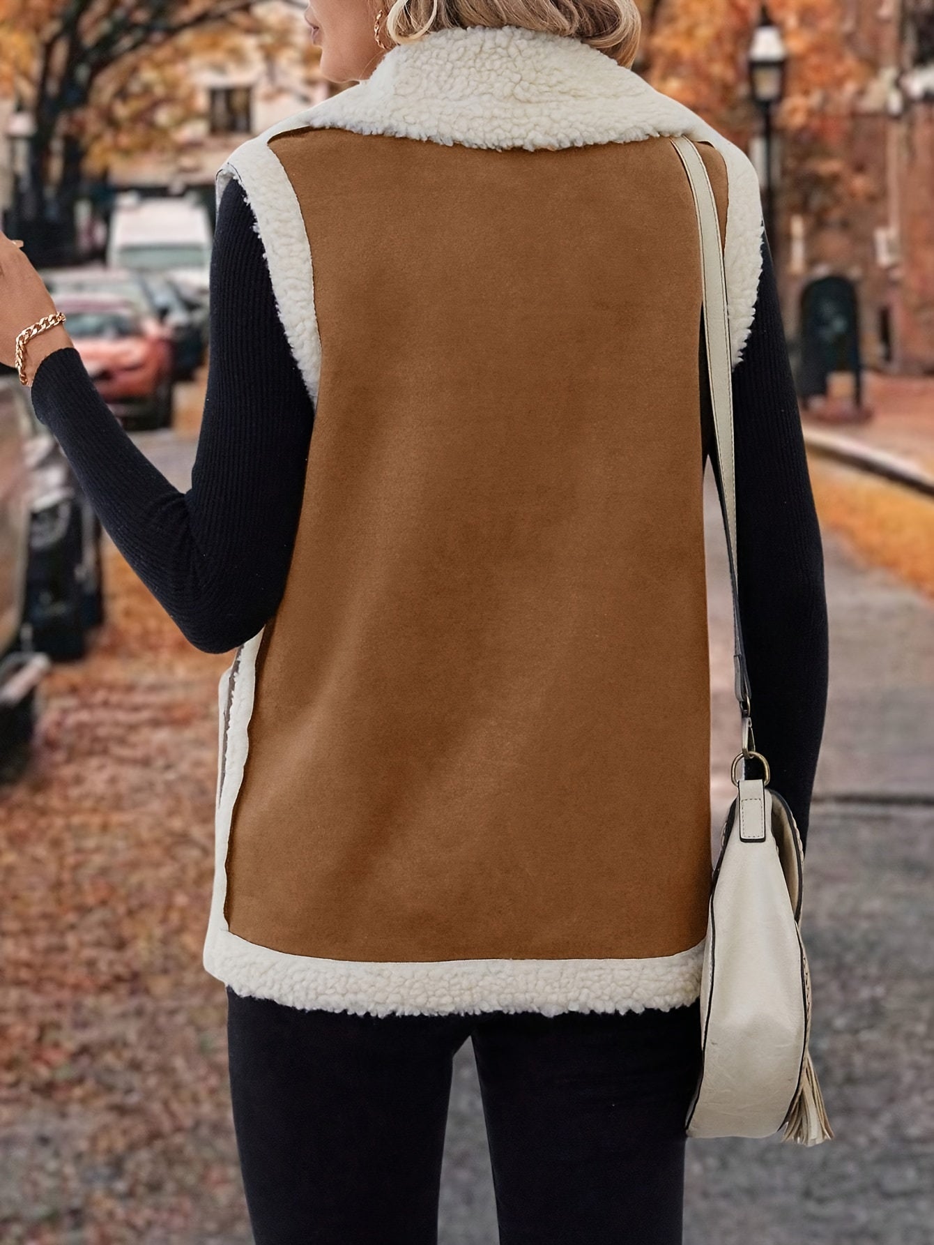 Chic solid color polyester sherpa vest with pockets and lapel collar for all-season warmth.